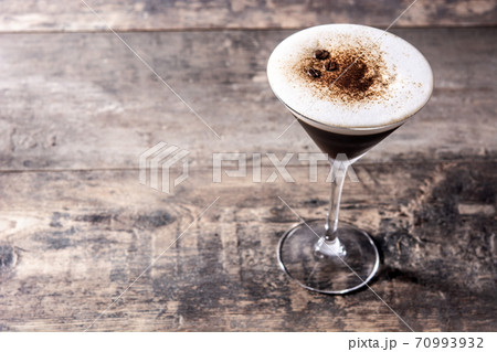 Martini espresso cocktail in glass on wooden table.Copy space Martini espresso cocktail in glass on wooden table.Copy space 70993932