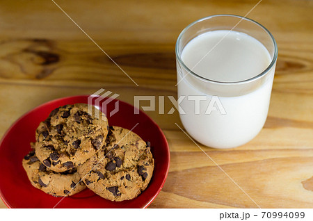 Chocolate Chip Cookies on red plate and Milk Chocolate Chip Cookies on red plate and Milk 70994099