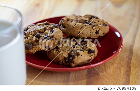 Chocolate Chip Cookies on red plate and Milk Chocolate Chip Cookies on red plate and Milk 70994108