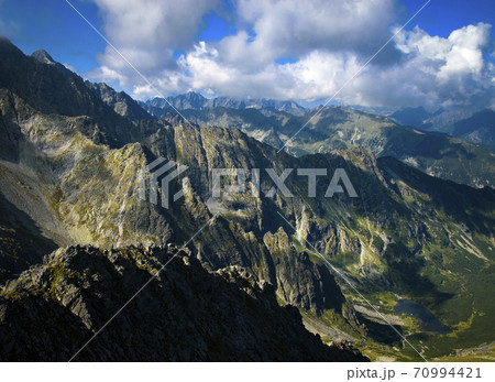 view down to a rocky mountain valley 70994421