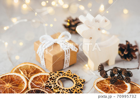 The figure of the reindeer, gift box, dry oranges and pine cone. The figure of the reindeer, gift box, dry oranges and pine cone. 70995732