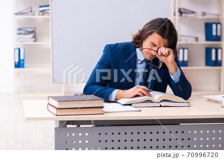 Young businessman student studying at workplace Young businessman student studying at workplace 70996720