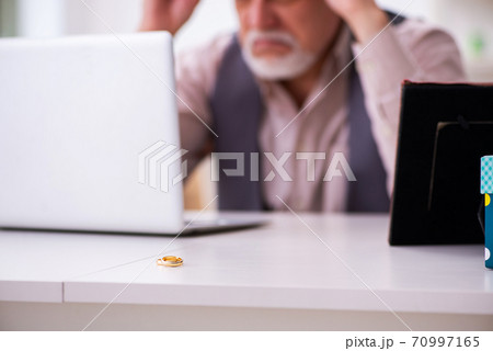 Old man doing marriage proposal via internet 70997165