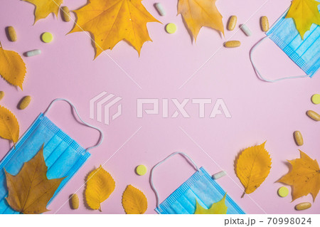 Autumn fallen leaves and medical masks and medicines on black background Autumn fallen leaves and medical masks and medicines on black background 70998024