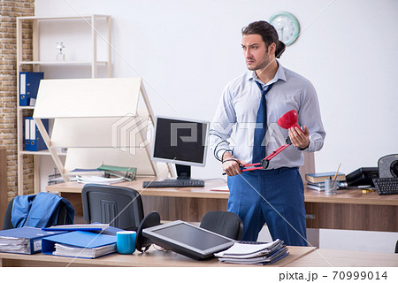 Young male employee unhappy with excessive work Young male employee unhappy with excessive work 70999014