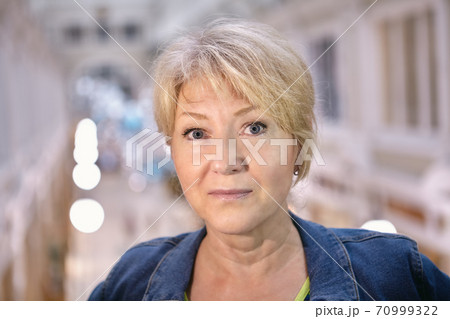 Beautiful white middle-aged woman's portrait in shopping mall. Beautiful white middle-aged woman's portrait in shopping mall. 70999322
