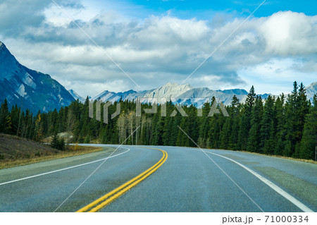 Rural road in the forest with mountains in the background. Alberta Highway 11 (David Thompson Hwy), Jasper National Park, Canada. 71000334