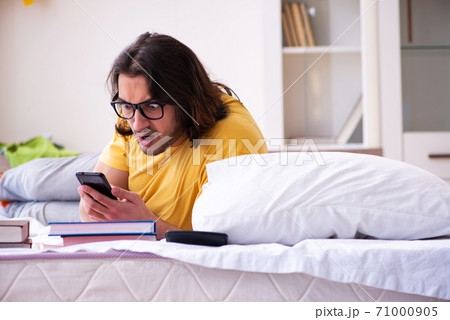 Young male student preparing for exams at home Young male student preparing for exams at home 71000905