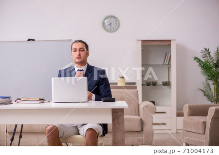 Young male employee working at home during pandemic disease Young male employee working at home during pandemic disease 71004173