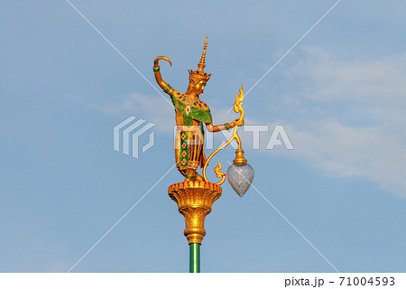 Public lighting poles adorned with statues of young women wearing ancient cultural costumes. Looks in a graceful dance. Public lighting poles adorned with statues of young women wearing ancient cultural costumes. Looks in a graceful dance. 71004593