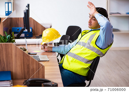 Young male architect working in the office 71006000