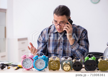 Young male watchmaker working in the workshop Young male watchmaker working in the workshop 71006361