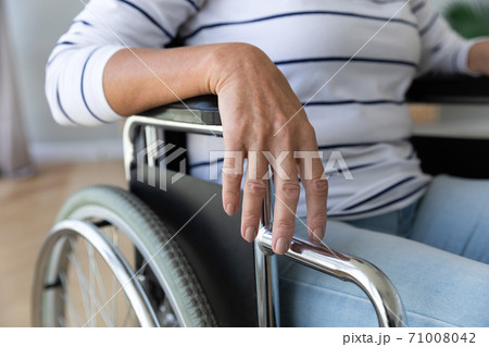Disabled paraplegic handicapped old woman sit on wheelchair, close up 71008042