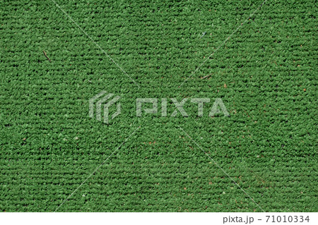 Fake grass green background texture. Fiber backdrop 71010334