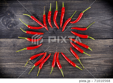 top view of spicy red chili pepper on wooden surface.Selective focus top view of spicy red chili pepper on wooden surface.Selective focus 71010568