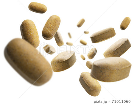Yellow tablets levitate on a white background Yellow tablets levitate on a white background 71011060