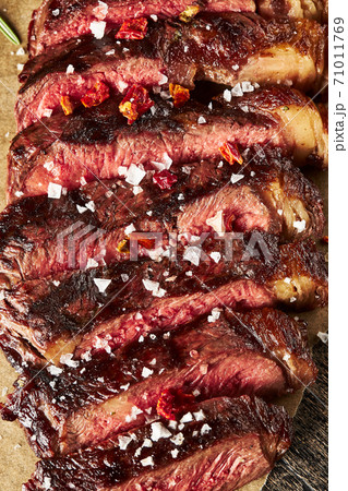 Close up of grilled Medium Rare Ribeye steak with salt cristals Close up of grilled Medium Rare Ribeye steak with salt cristals 71011769