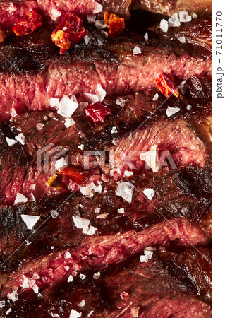 Close up of grilled Medium Rare Ribeye steak with salt cristals Close up of grilled Medium Rare Ribeye steak with salt cristals 71011770