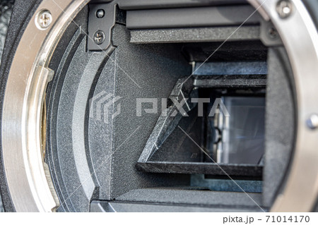 The mirror of digital Camera APS-C and lens mount , close-up. The mirror of digital Camera APS-C and lens mount , close-up. 71014170