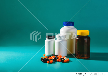 Bottle and Pills On green Background. Medicine Healthcare Pharmacy Concept. Coronavirus. Bottle and Pills On green Background. Medicine Healthcare Pharmacy Concept. Coronavirus. 71019836