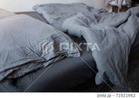 Blue bed sheets and pillows after night's sleep. Blue bed sheets and pillows after night's sleep. 71021662