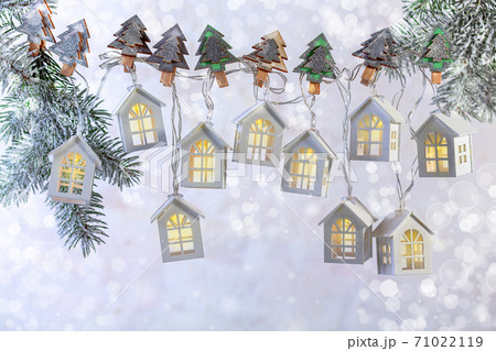 Beautiful Christmas garland of lights in the form of white houses. Beautiful Christmas garland of lights in the form of white houses. 71022119