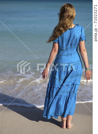 young woman in a romantic dress on sand near the sea, Cuba, Varadero 71023271