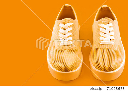 Pink sneakers on a bright fuchsia background. Pink sneakers on a bright fuchsia background. 71023673
