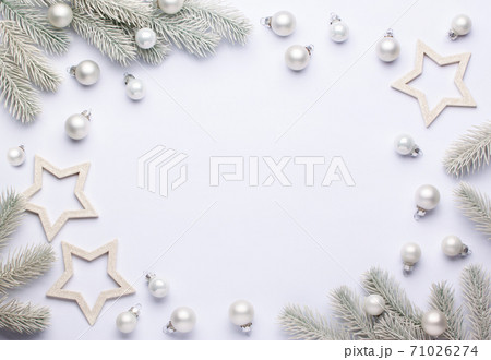 Light composition with white christmas balls and spruce branches. Light composition with white christmas balls and spruce branches. 71026274