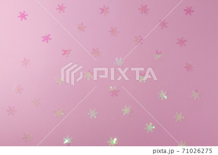 A gentle transparent white snowflake on a light pink background. A gentle transparent white snowflake on a light pink background. 71026275