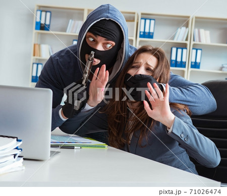 Criminal taking businesswoman as hostage in office 71026474