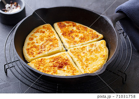 Traditional Scottish tattie potato scones in cast iron pan. Dark background. Close up. Traditional Scottish tattie potato scones in cast iron pan. Dark background. Close up. 71031758