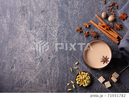 Indian masala tea with milk and spices in mug. Grey background. Copy space. Top view. 71031782