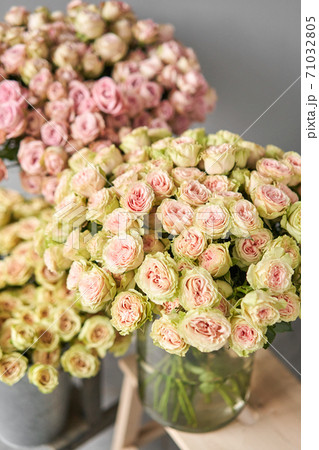 Big luxury bright bouquet peony rose on wooden table. Garden spray roses of lilac, pink and green color . bouquet in metal vase Big luxury bright bouquet peony rose on wooden table. Garden spray roses of lilac, pink and green color . bouquet in metal vase 71032805