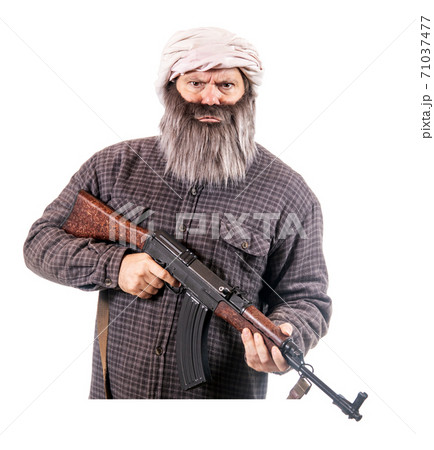 The bearded man armed with kalashnikov isolated on a white background.  71037477