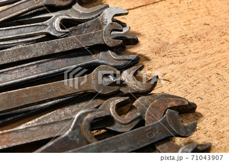 old vintage hand tools - set of wrenches on a wooden background with blank space for text old vintage hand tools - set of wrenches on a wooden background with blank space for text 71043907