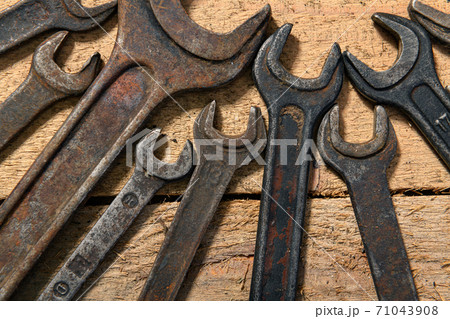 old vintage hand tools - set of wrenches on a wooden background with blank space for text old vintage hand tools - set of wrenches on a wooden background with blank space for text 71043908