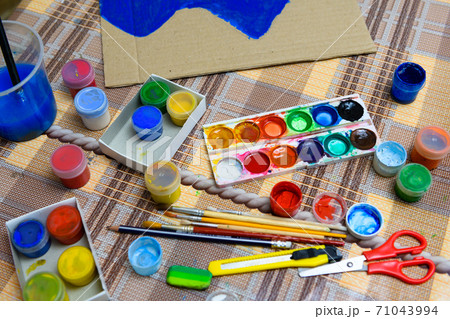 watercolor paints and paper closeup for drawing, artistic creation at home, workspace for make creative artwork 71043994