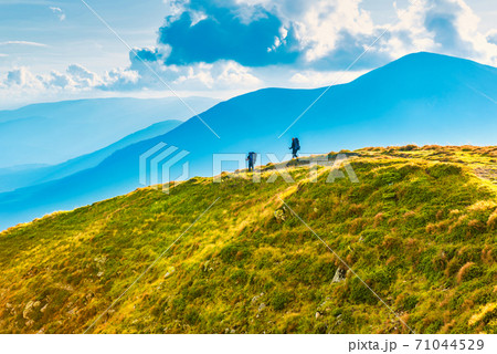 People travelling in mountains 71044529