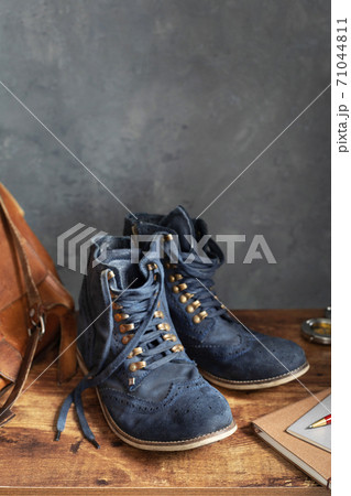 travel vintage old boots shoes at wooden desk table travel vintage old boots shoes at wooden desk table 71044811