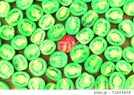Green sliced tomato with red tomato 71044858