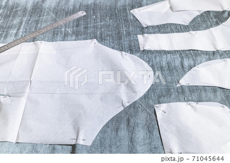 fixed paper sewing pattern layouts on gray fabric fixed paper sewing pattern layouts on gray fabric 71045644