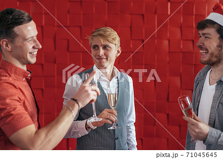 Three young men celebrate Christmas or New Year 71045645