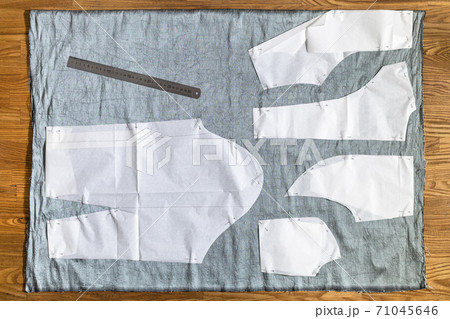top view of paper layout of pattern on gray fabric top view of paper layout of pattern on gray fabric 71045646