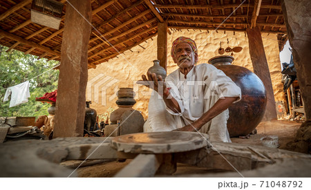 Potter at work makes ceramic dishes. Rajasthan. Potter at work makes ceramic dishes. Rajasthan. 71048792