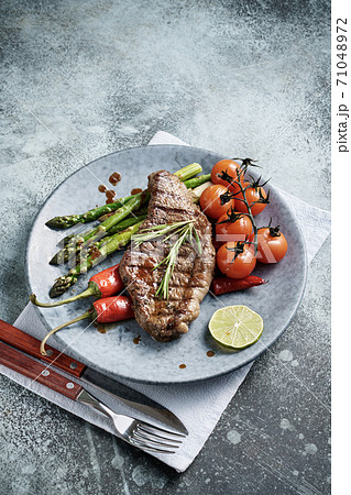 Beef steak with cherry tomato and asparagus 71048972
