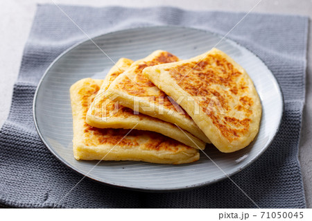 Traditional Scottish tattie potato scones on a plate. Grey background. Close up. 71050045