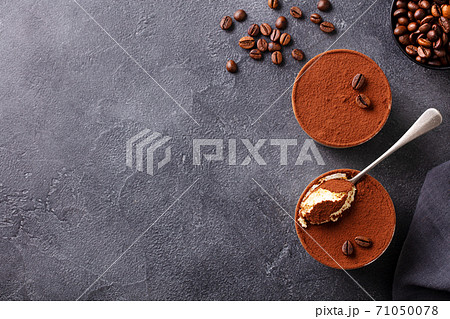 Tiramisu dessert in glasses. Dark grey background. Copy space. Top view. Tiramisu dessert in glasses. Dark grey background. Copy space. Top view. 71050078