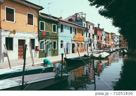 Panoramic view of coloured homes and water canal with boats in Burano Panoramic view of coloured homes and water canal with boats in Burano 71051830