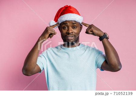 African american man wearing Santa hat 71052139